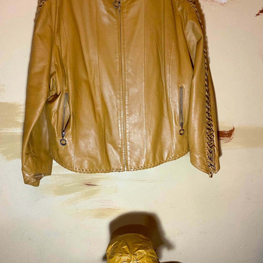 Womens leather jacket with a bucket hat to match.